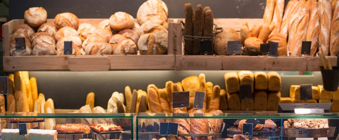 A shelf full of different types of bread