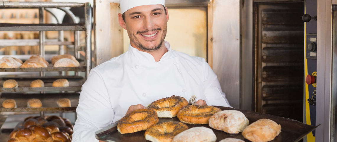 A baker holding some pastries.